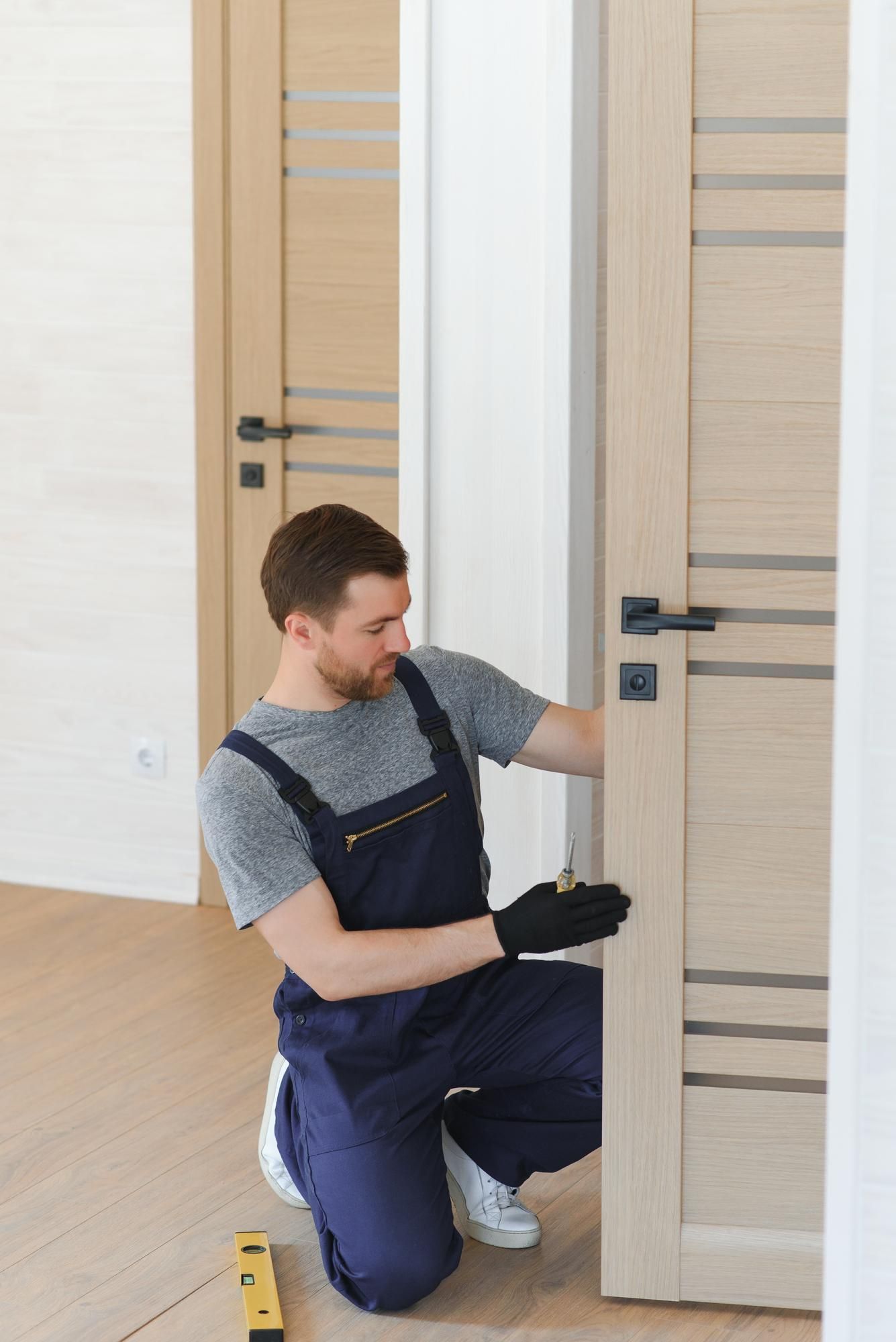 a man is installing a door in a room