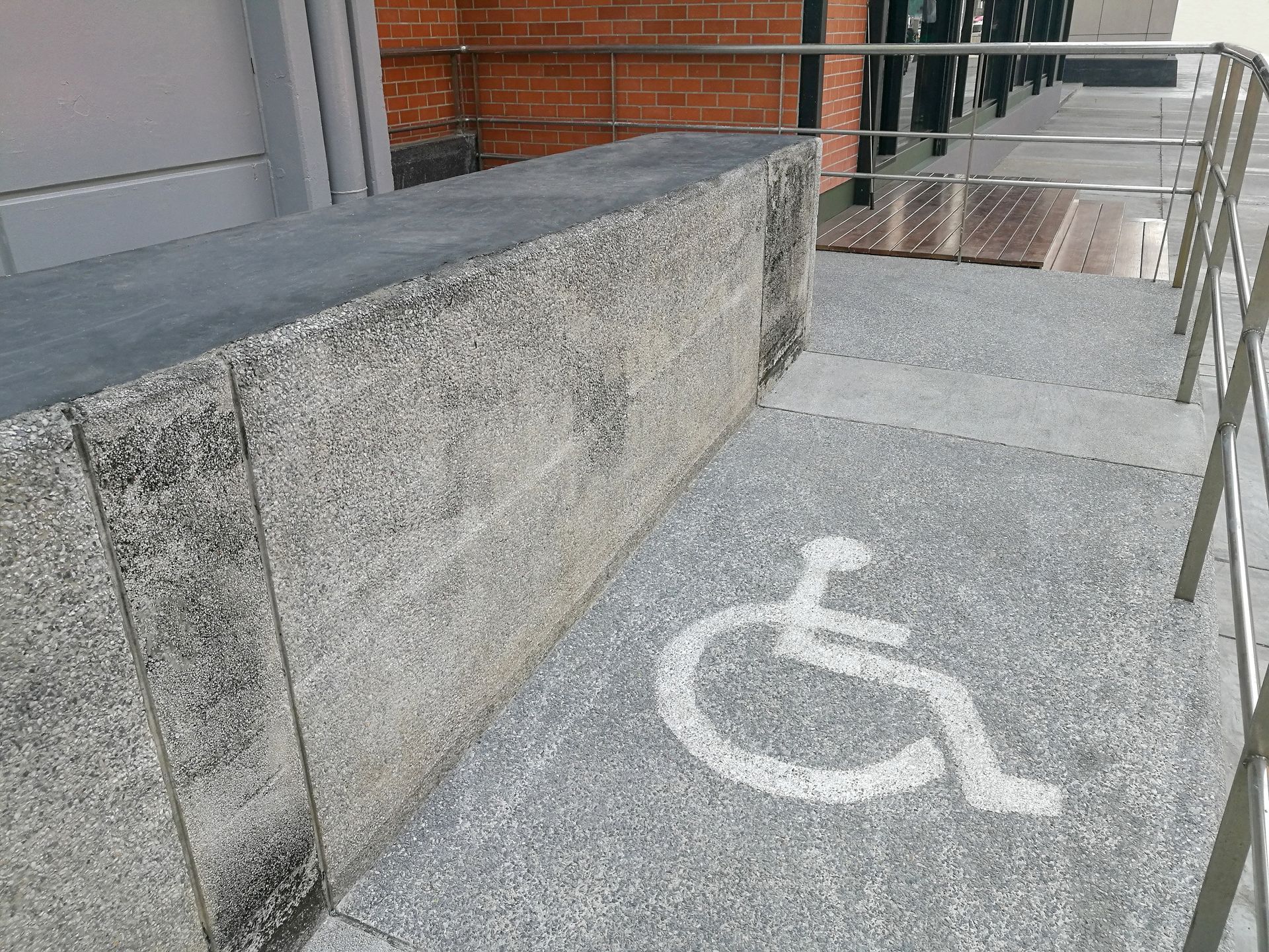 a handicapped sign is painted on the side of a ramp