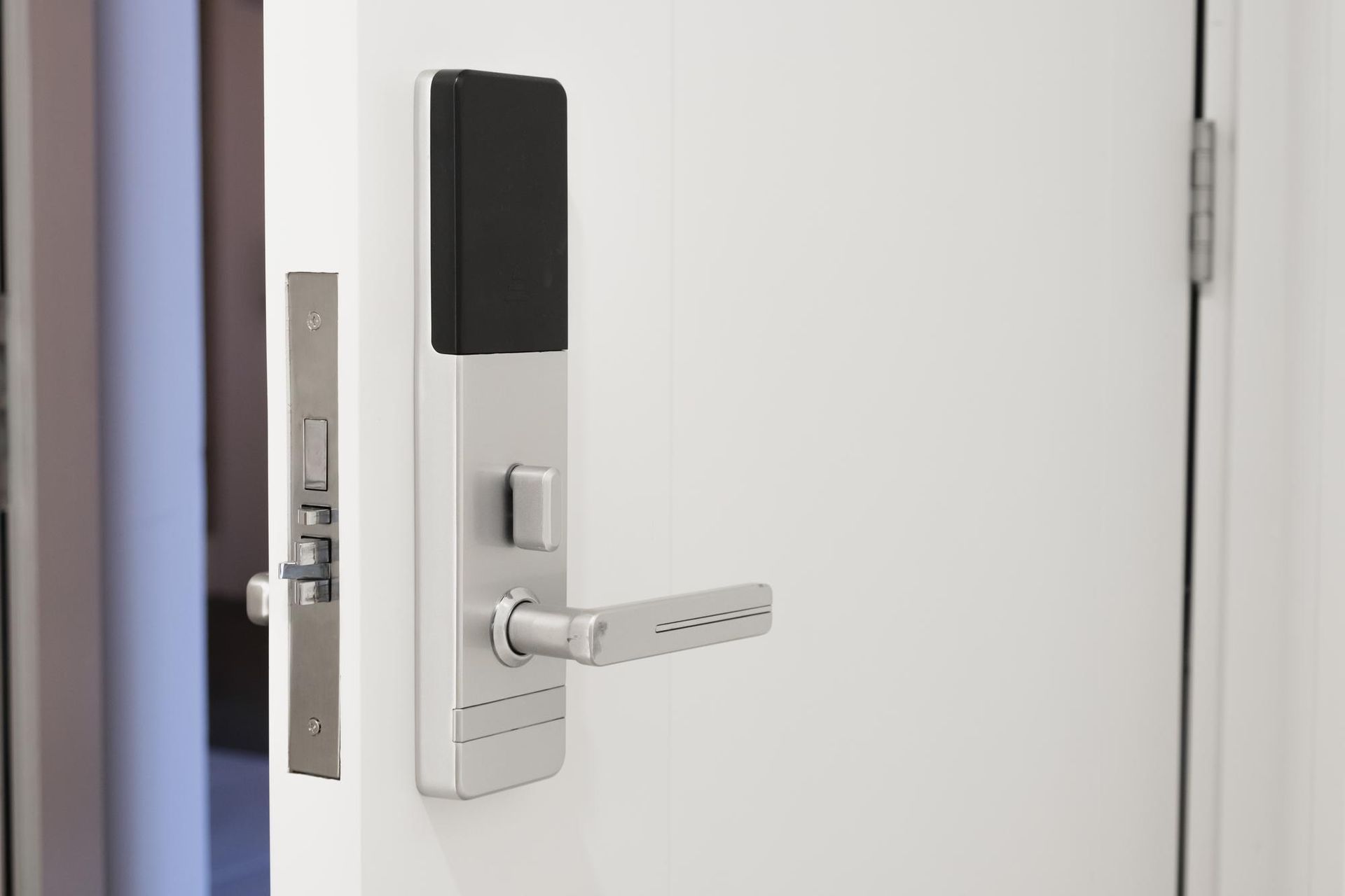 a white door with a smart door lock on it .