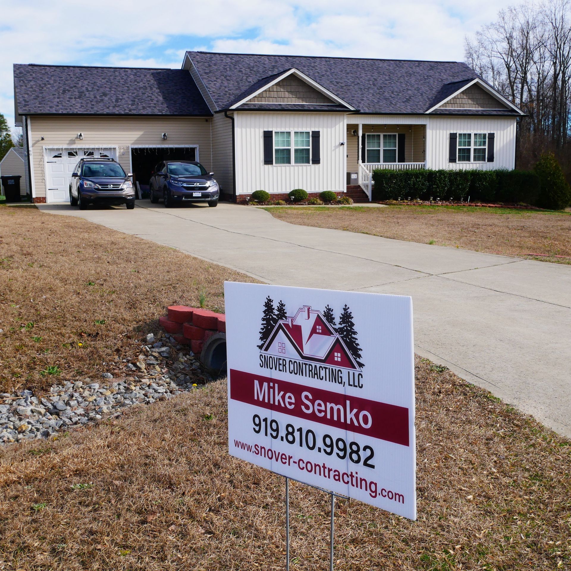 A house with a for sale sign in front of it