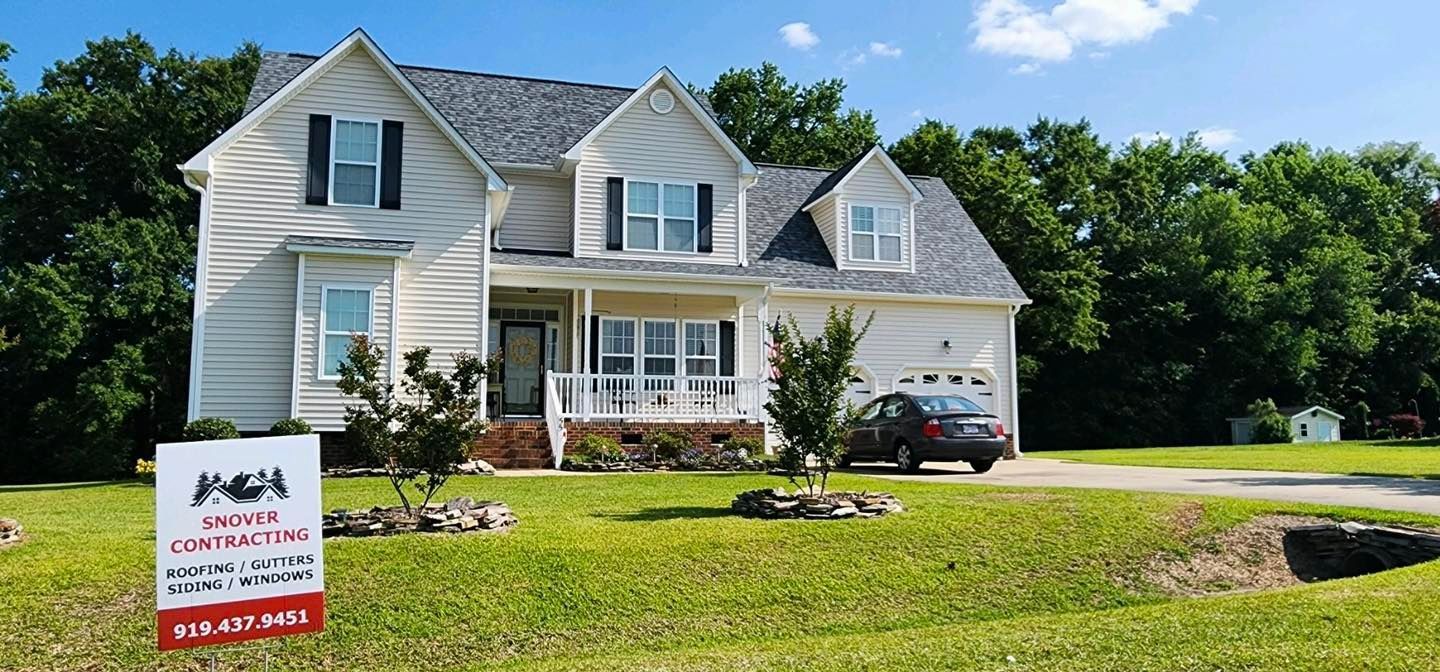 A house with a for sale sign in front of it
