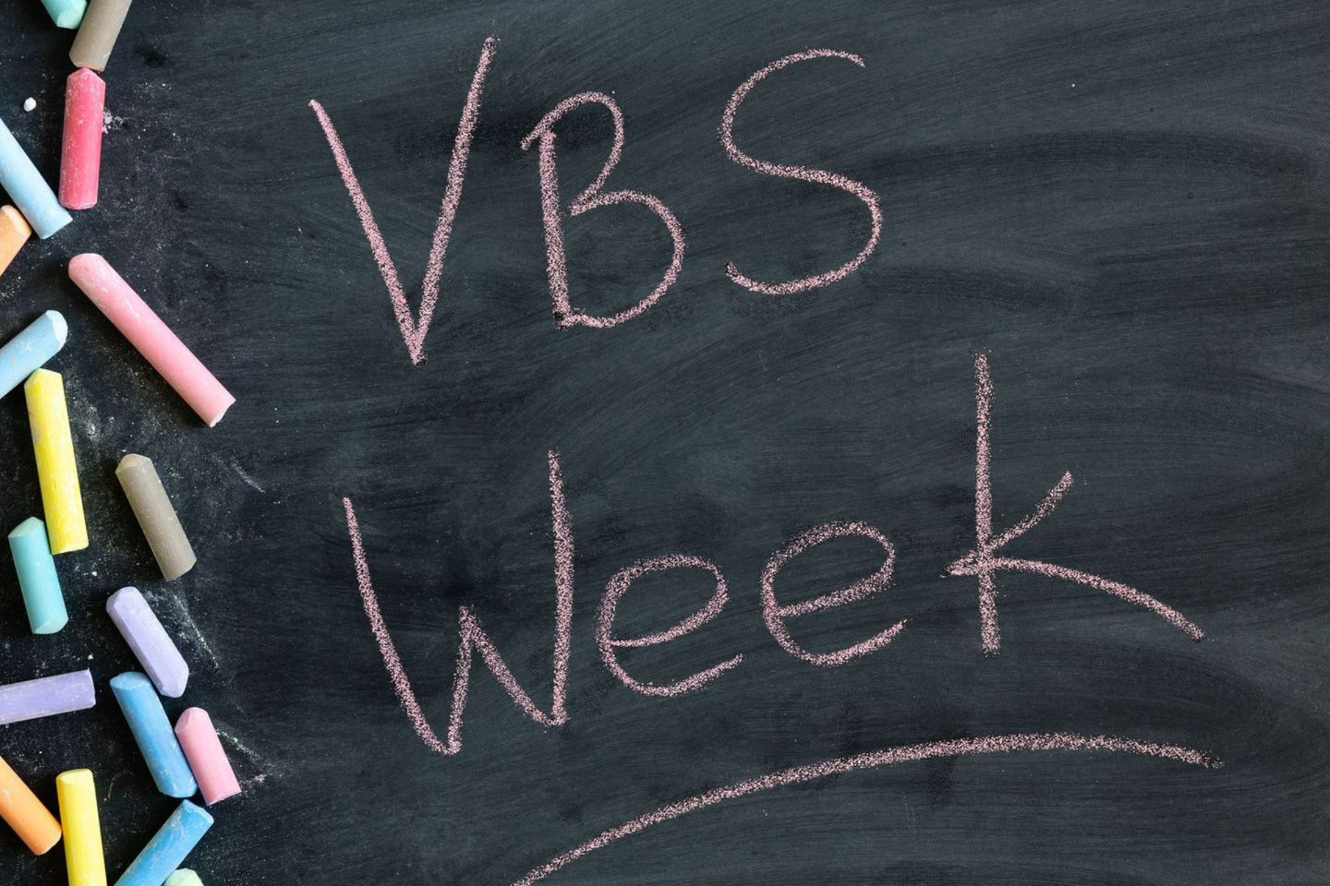 A chalkboard with the words vbs week