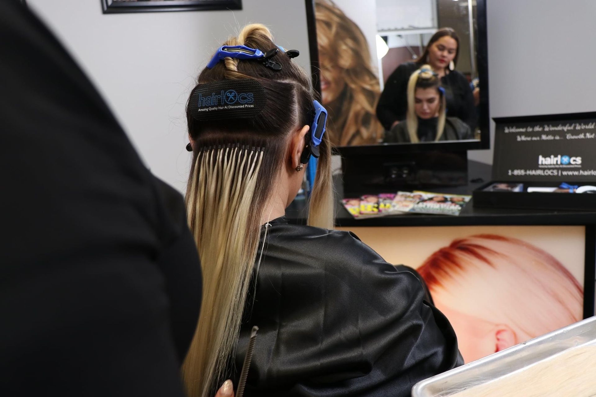 a woman is getting her hair done in a salon .