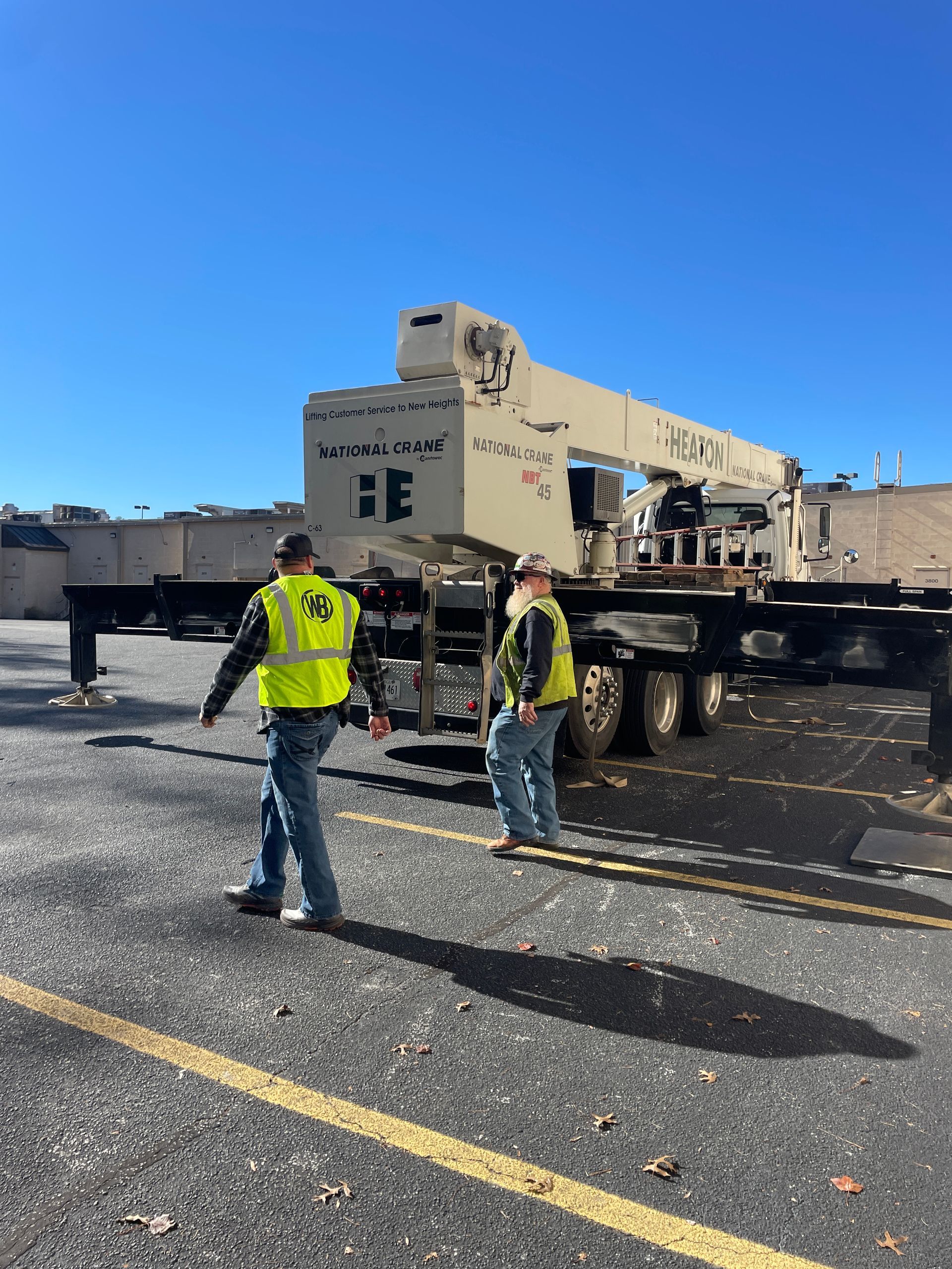 Two vans are parked next to each other in a driveway.