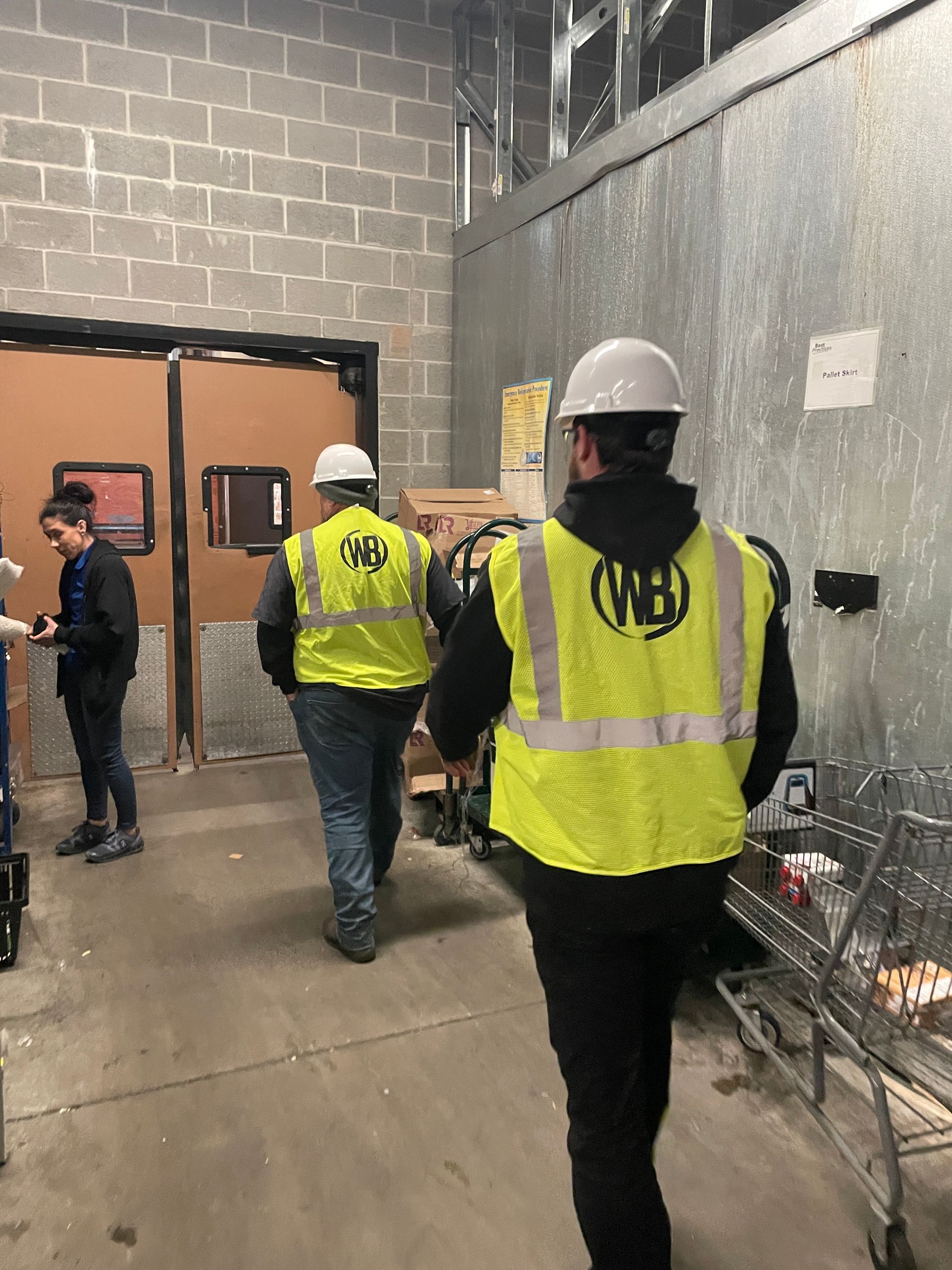 An air conditioner is being repaired on the side of a building.
