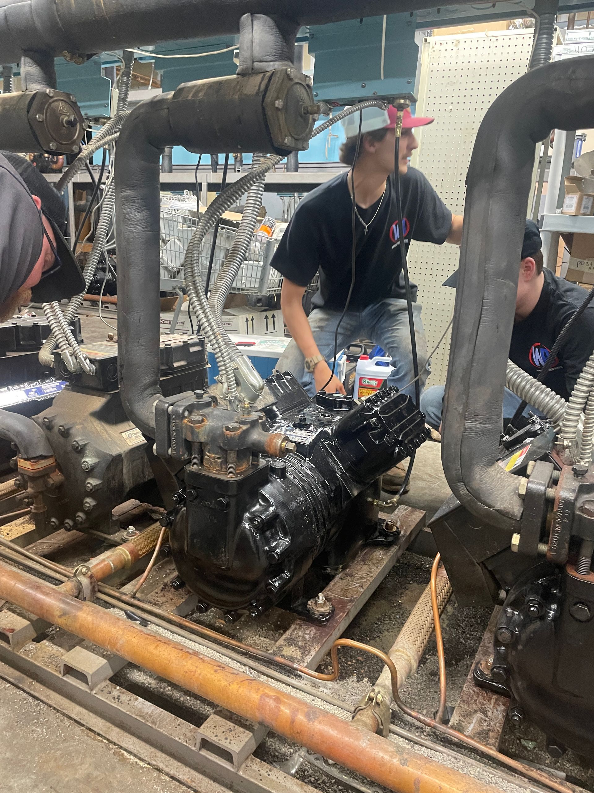 A group of men are working on a machine in a factory.