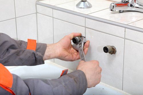 Experienced plumber working in a bathroom in Bristol, CT