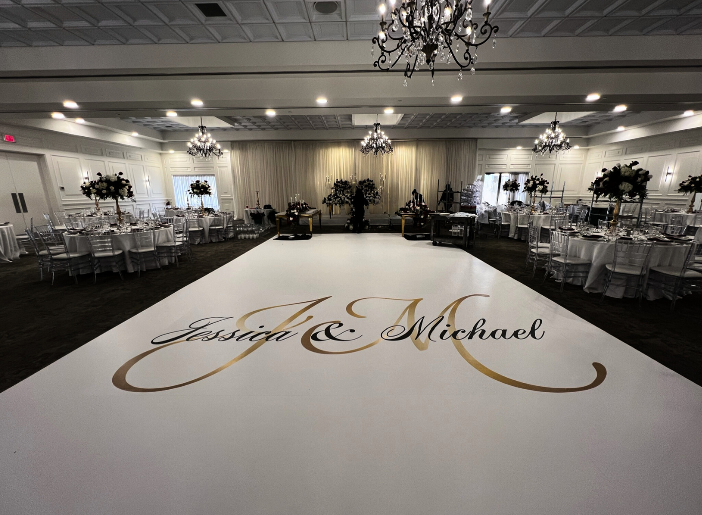 There is a dance floor with the names of the bride and groom on it.
