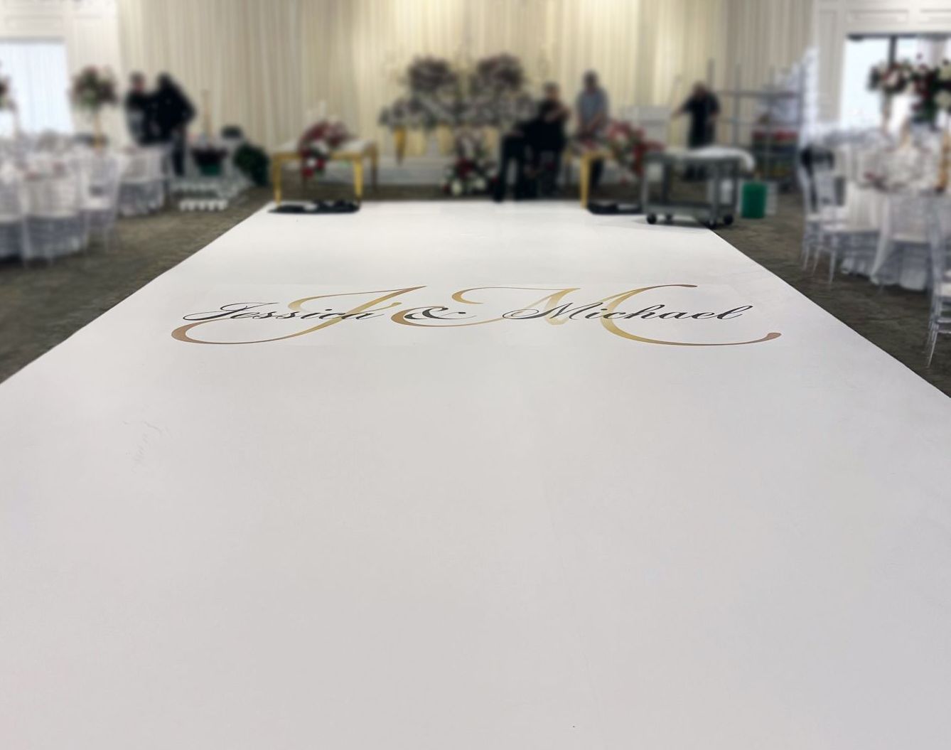 A white carpet with arabic writing on it is in a room with tables and chairs.