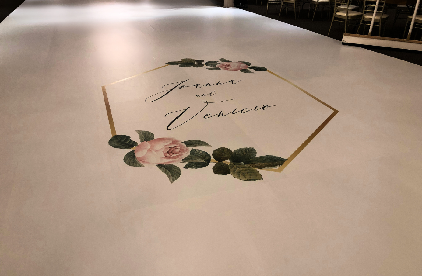 A white table cloth with a floral design on it.