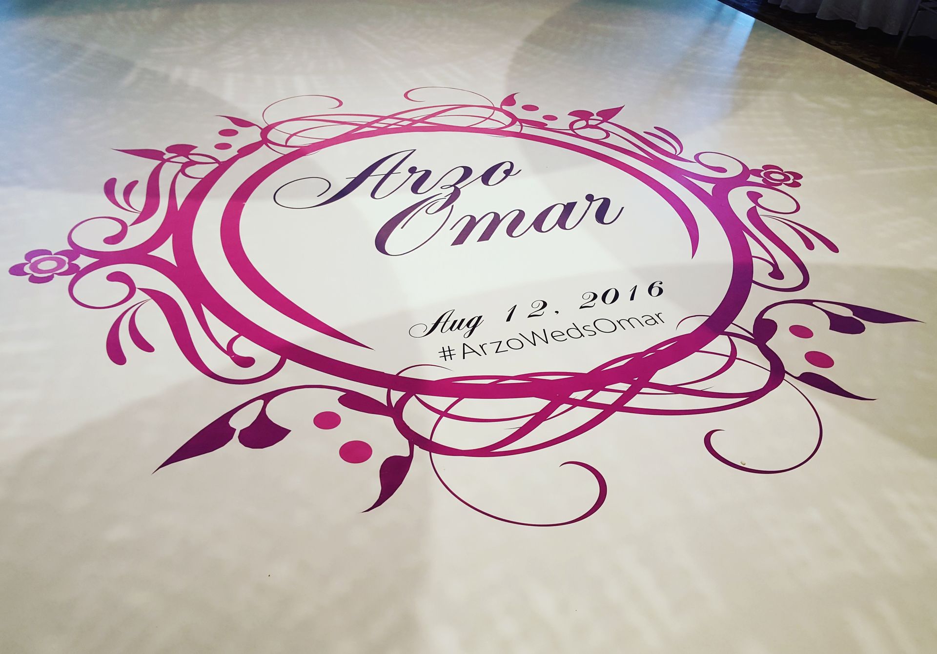 A purple and white logo on a white surface