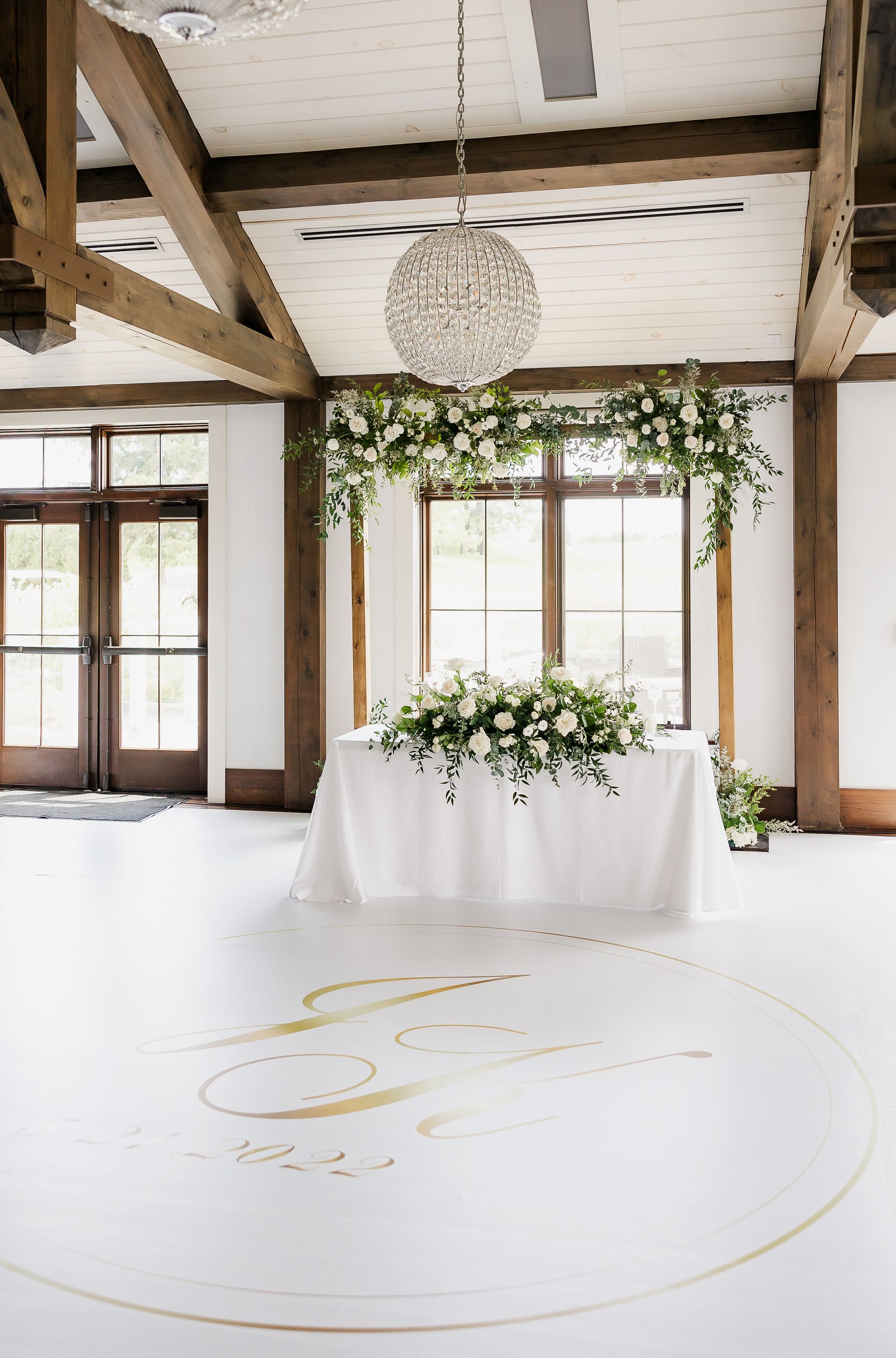 There is a table with flowers on it in the middle of the room.
