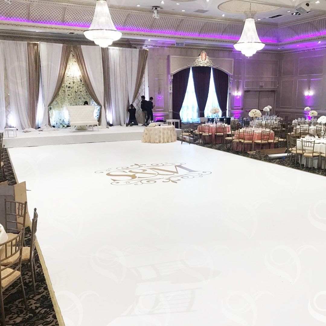 There is a large white dance floor in the middle of the room.