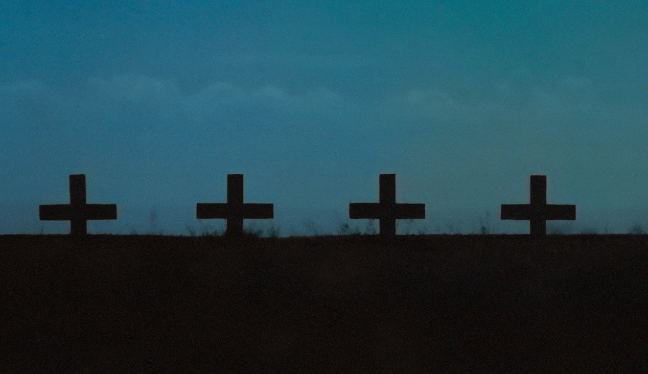 Headstones on a teal sky background