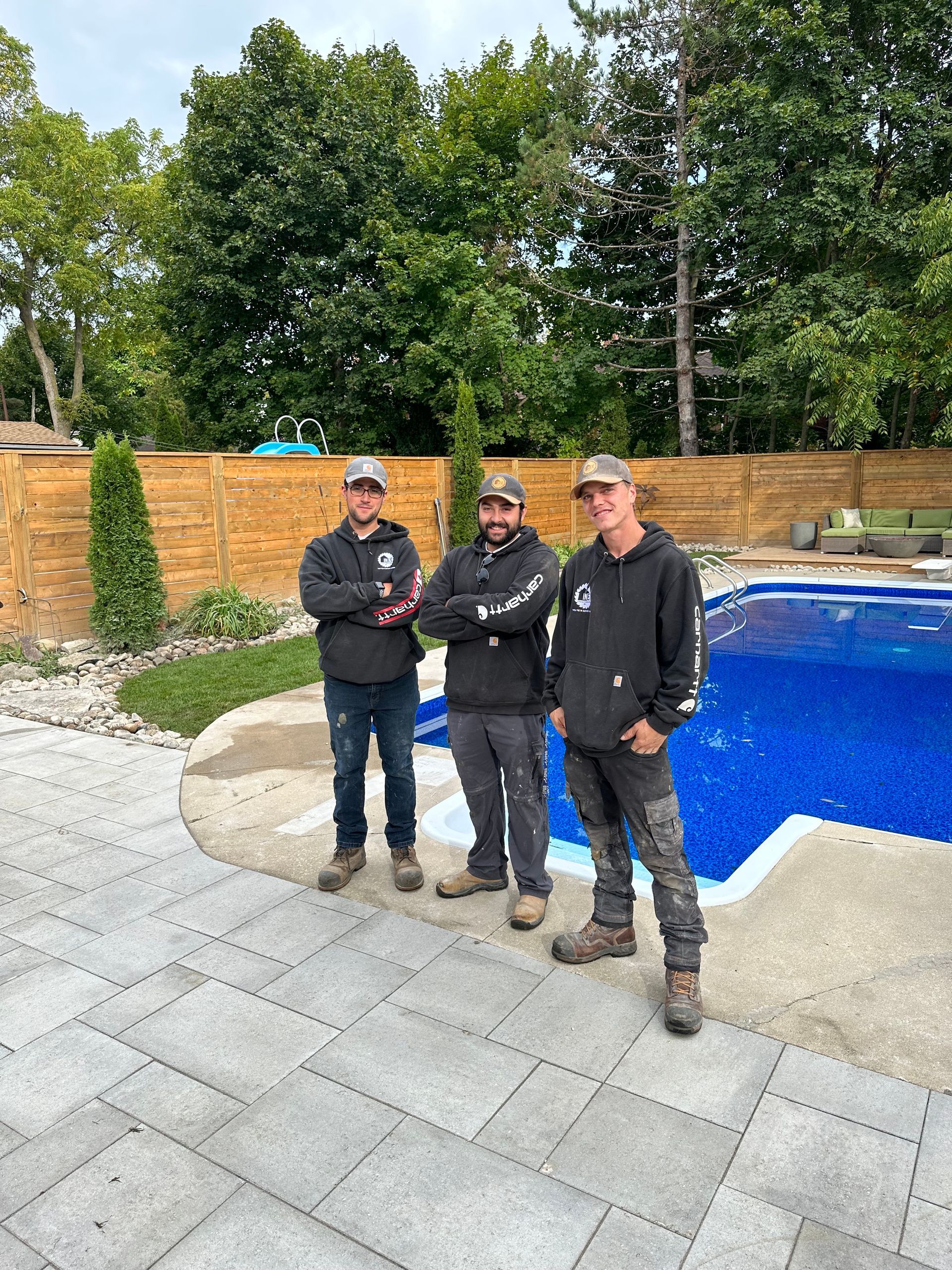 workers crossing arms standing on renovated flooring