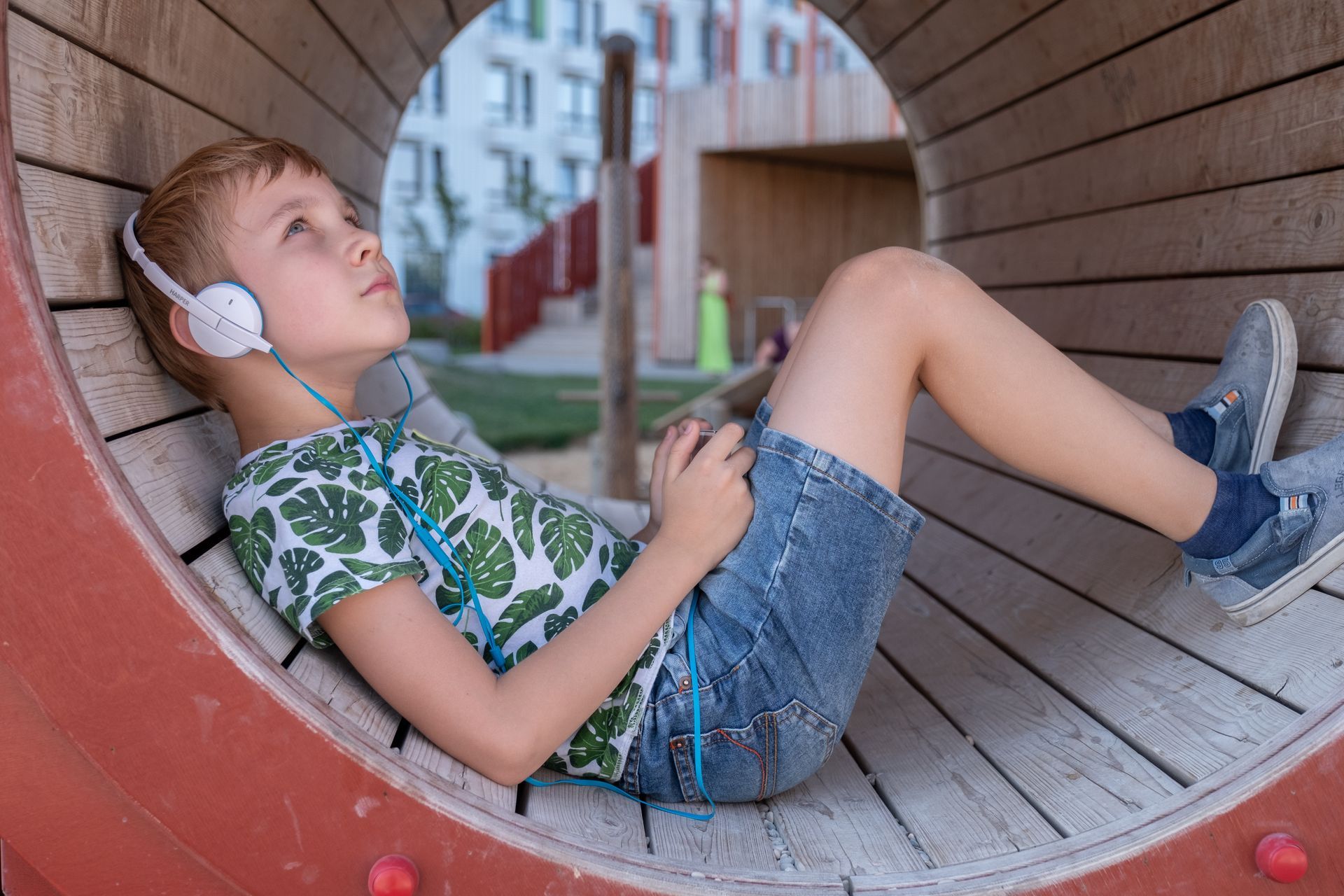 A young boy is looking through a magnifying glass.