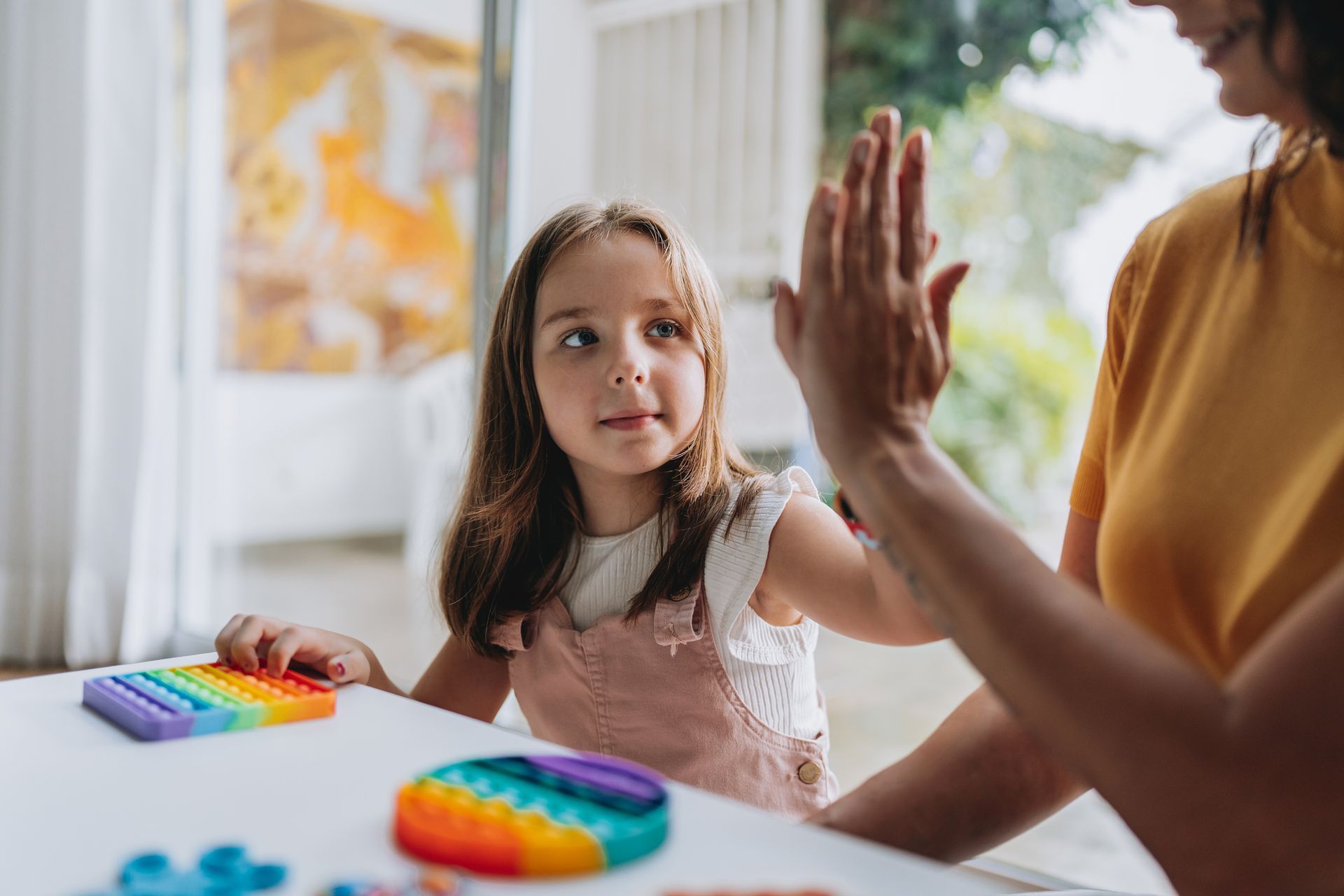 Mother playing with autistic daughter