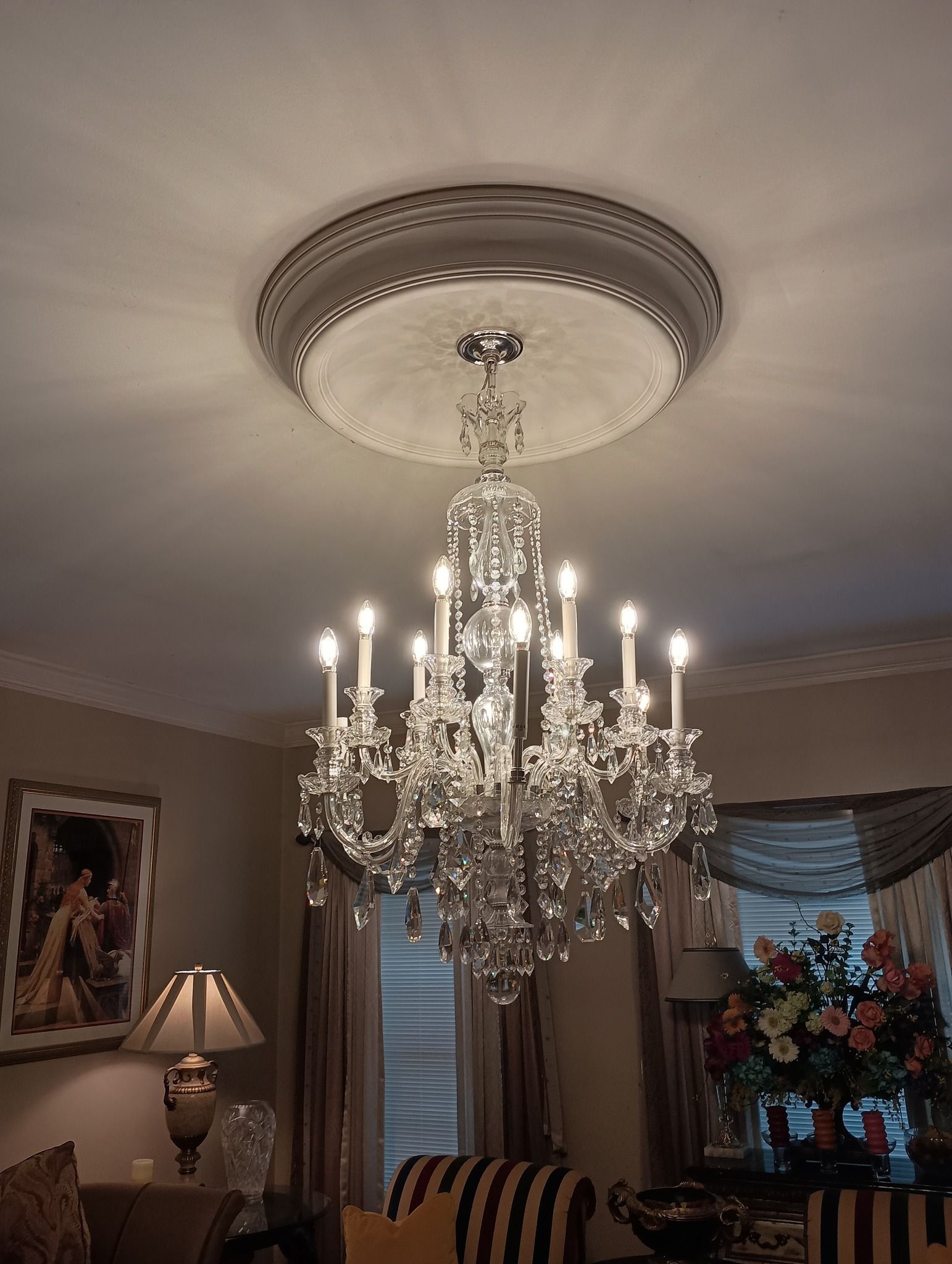 Crystal chandelier hanging from a decorative ceiling medallion.
