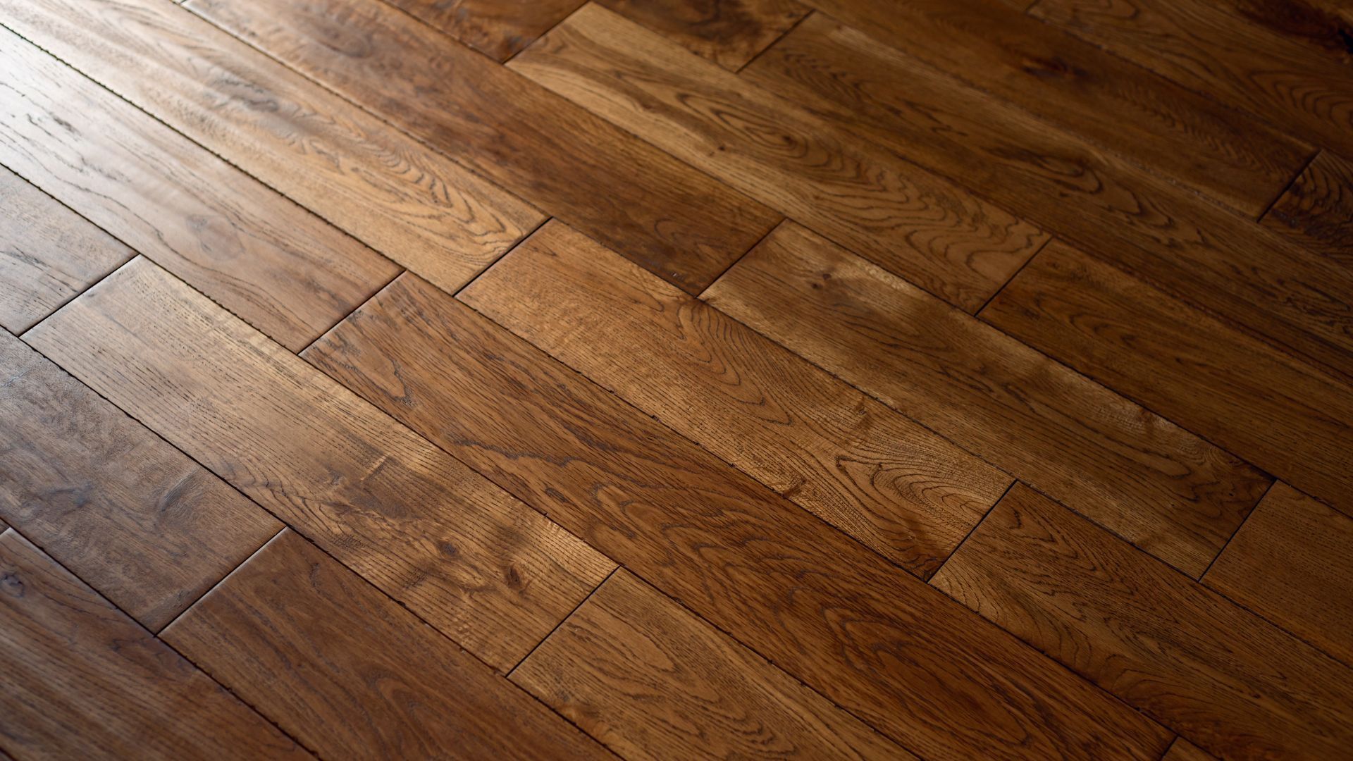 A close up of a wooden floor with a diagonal pattern.