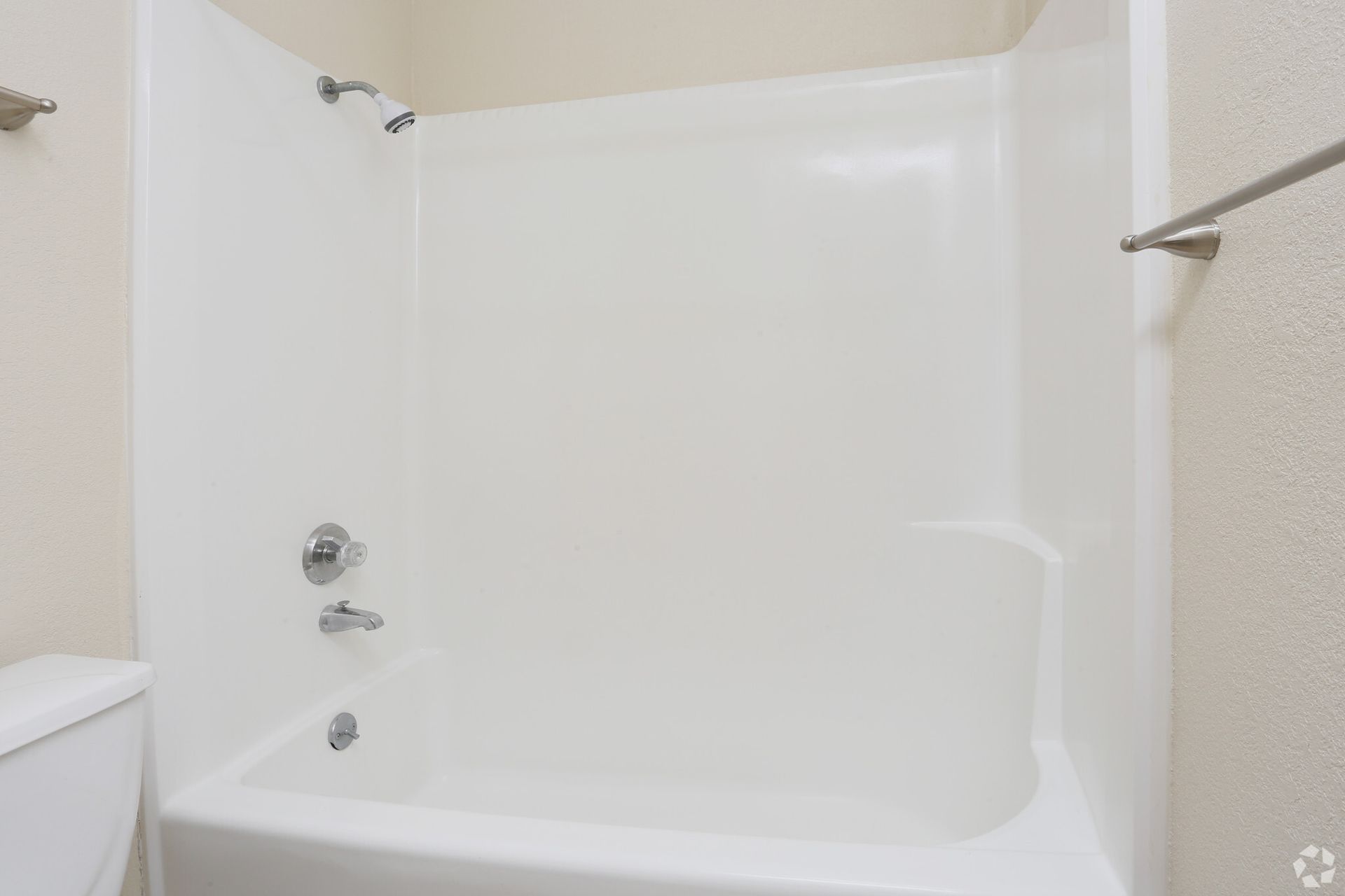 A bathroom with a bathtub and a toilet.