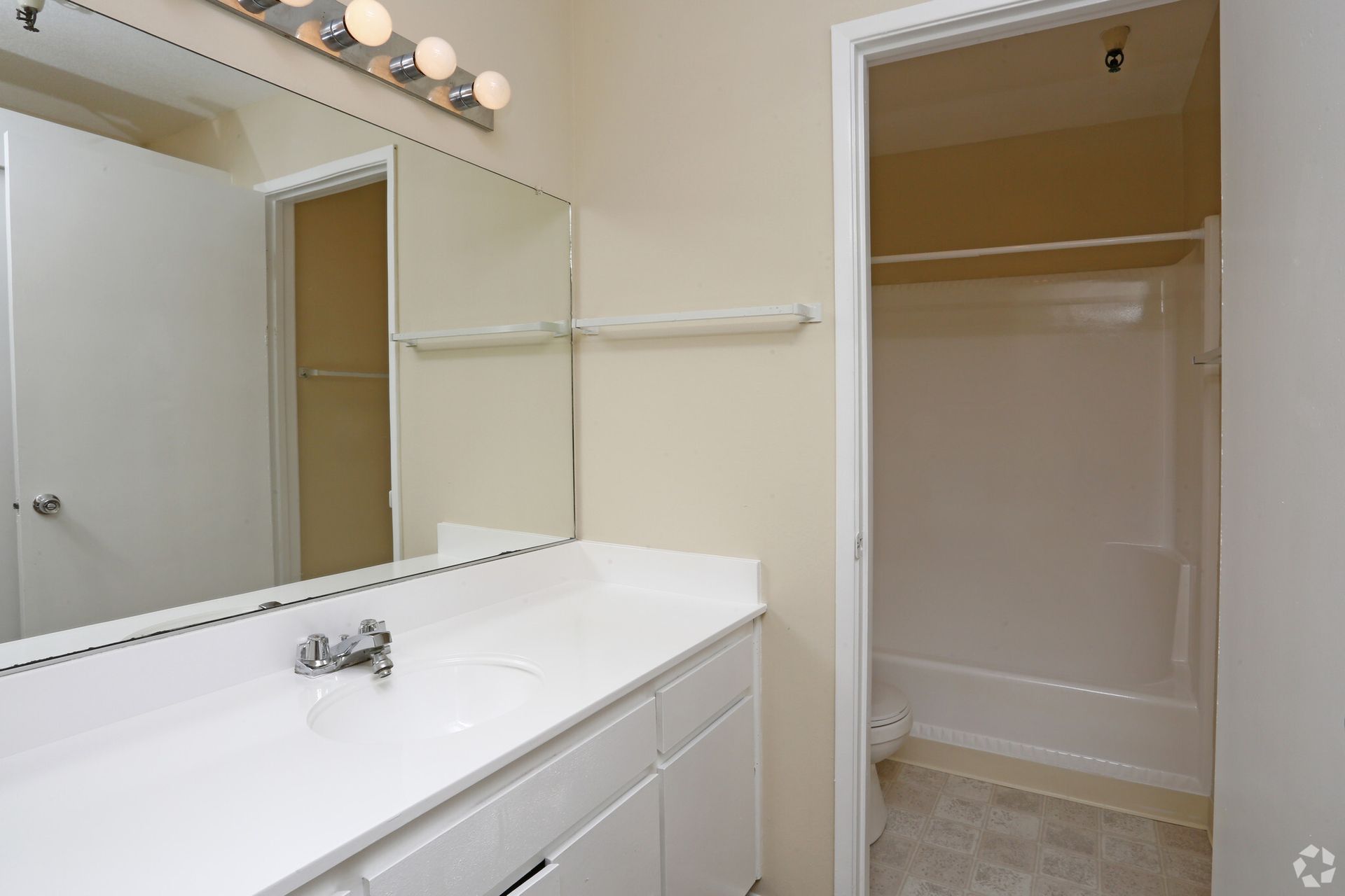 A bathroom with a sink and a large mirror