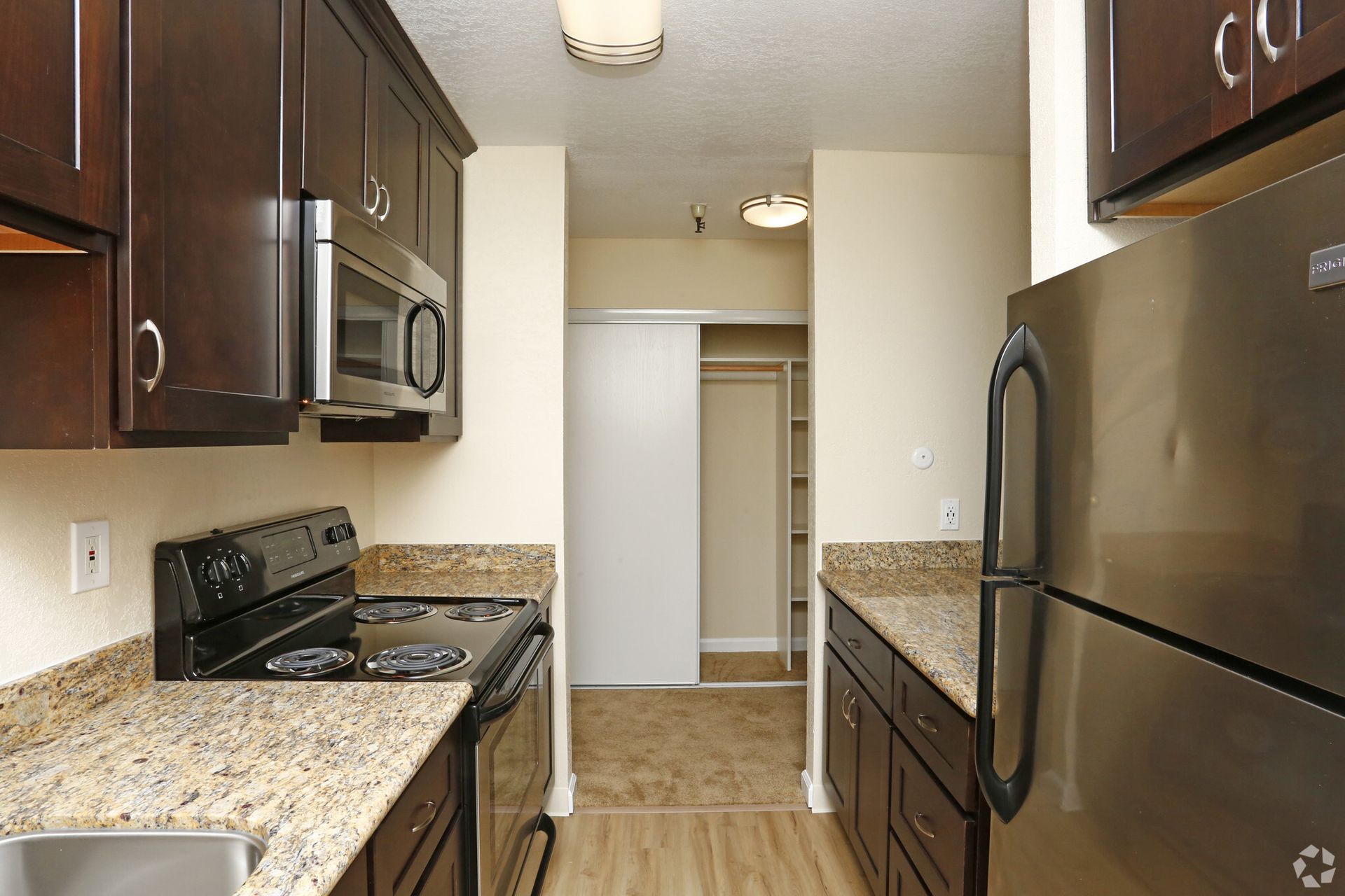 A kitchen with stainless steel appliances and granite counter tops
