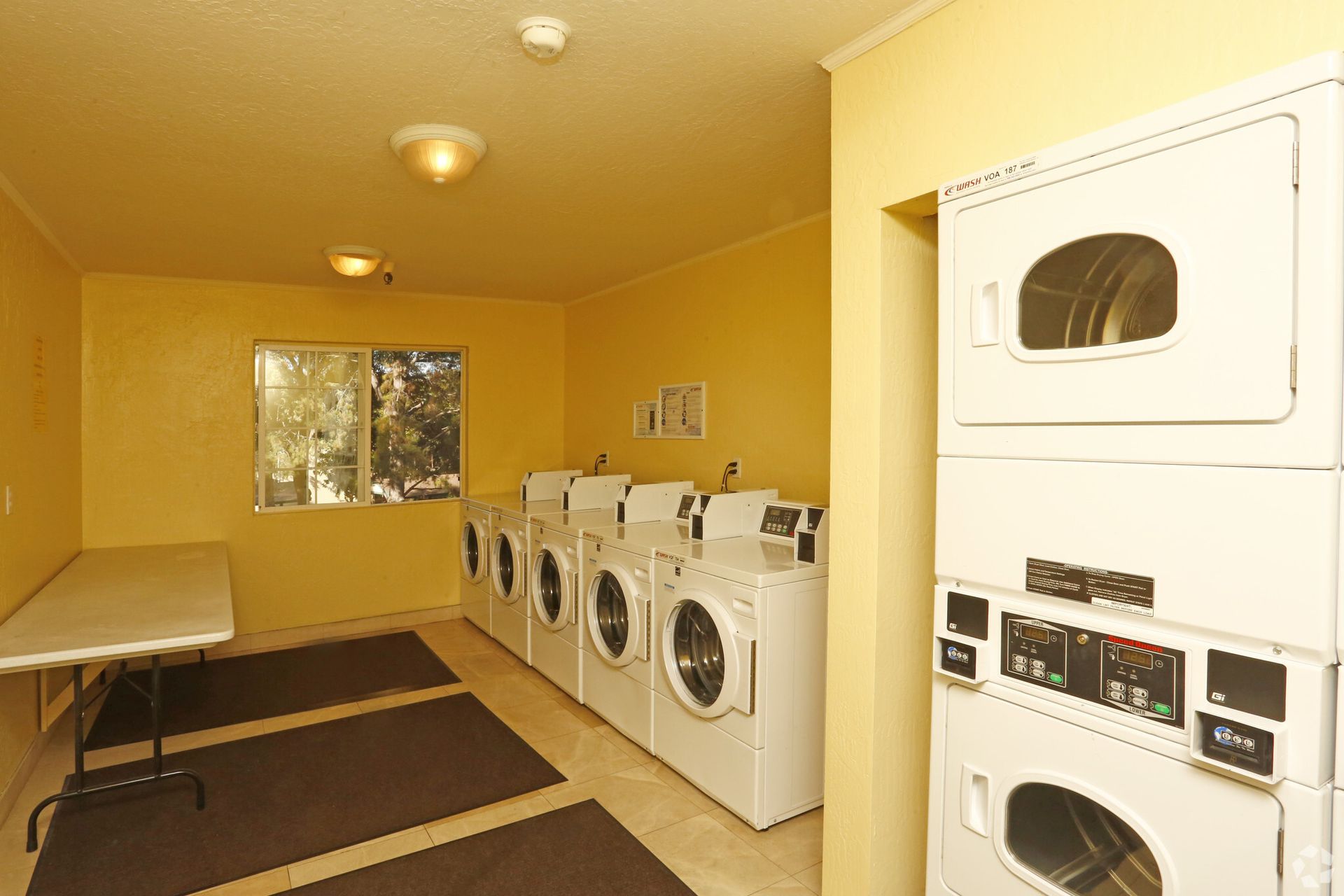A laundromat with washers and dryers stacked on top of each other
