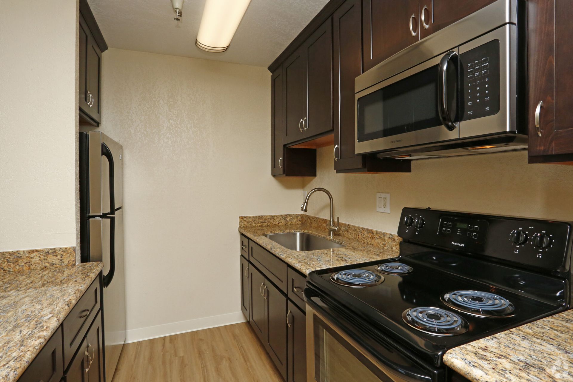 A kitchen with stainless steel appliances and granite counter tops