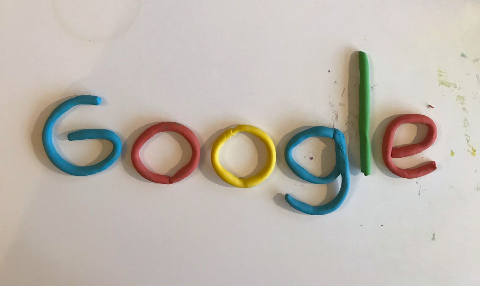 Google logo made from colorful clay letters on a light background