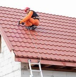 Roofing contractor replacing a tile roof