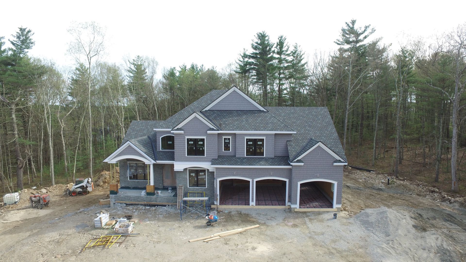 A large house is being built in the middle of a forest.