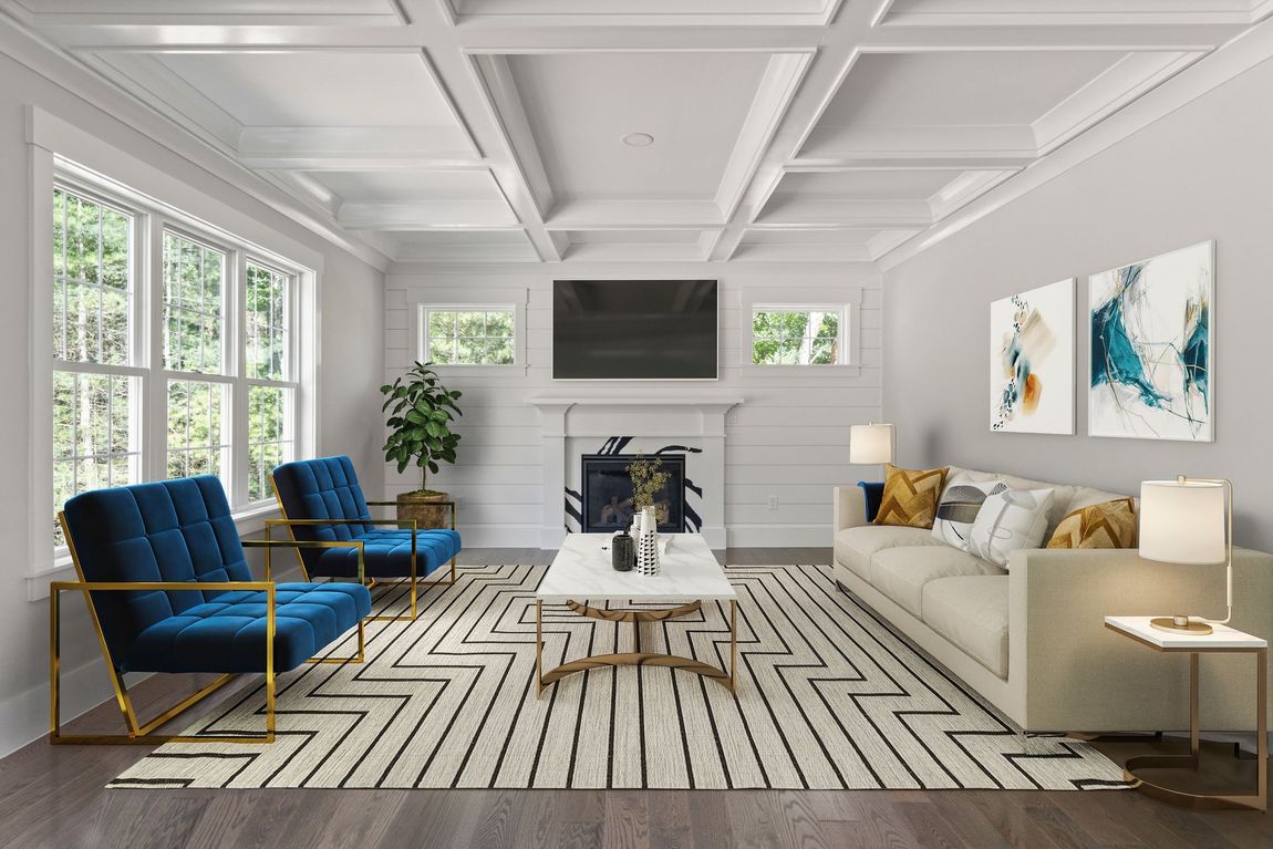 A living room with a couch , chairs , coffee table and television.