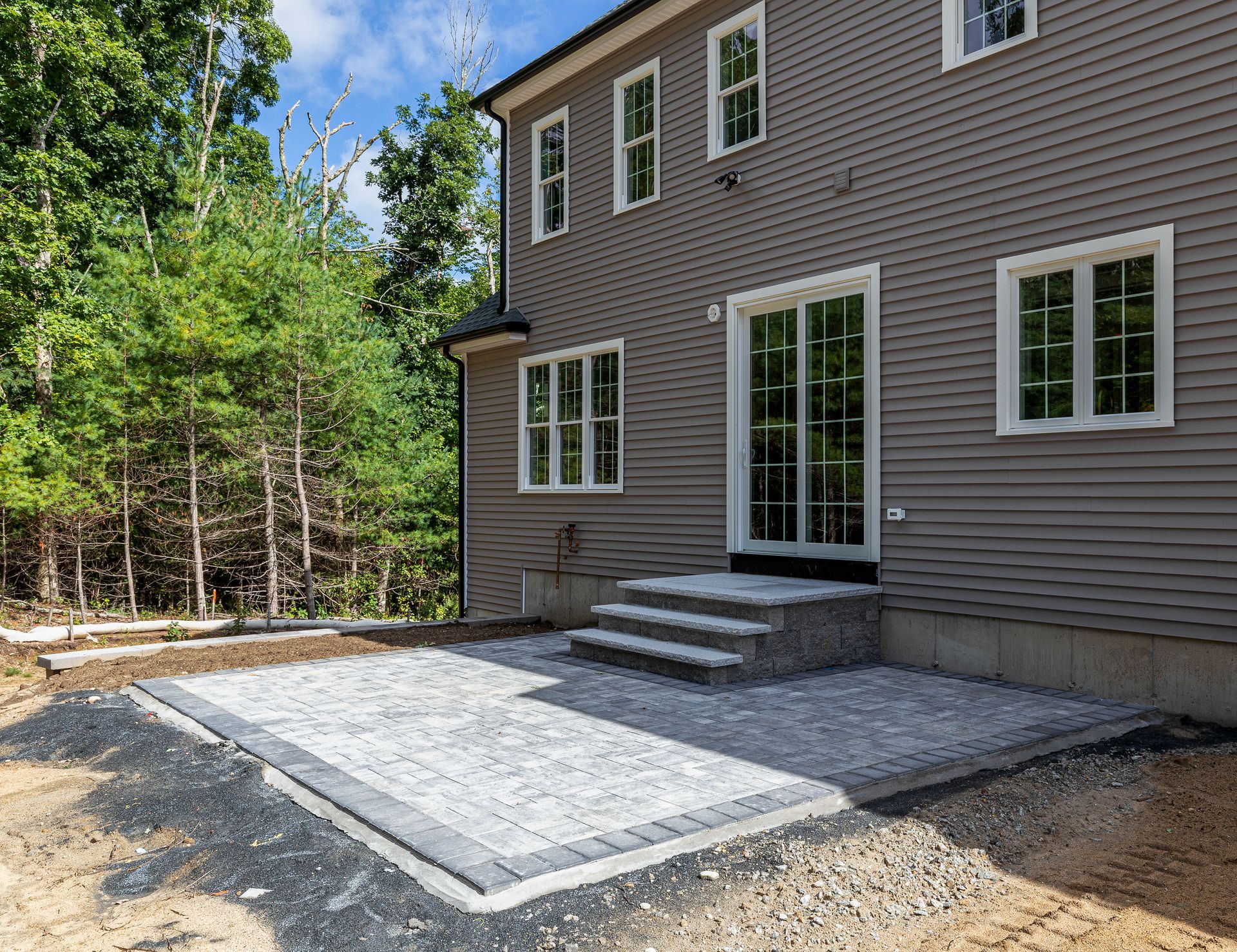 A large house with a patio in front of it.