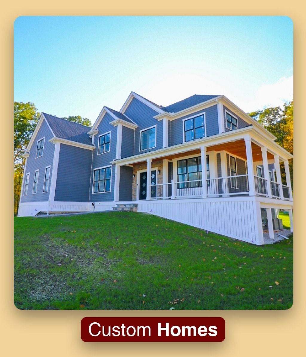 A large house with a large porch is sitting on top of a lush green hill.