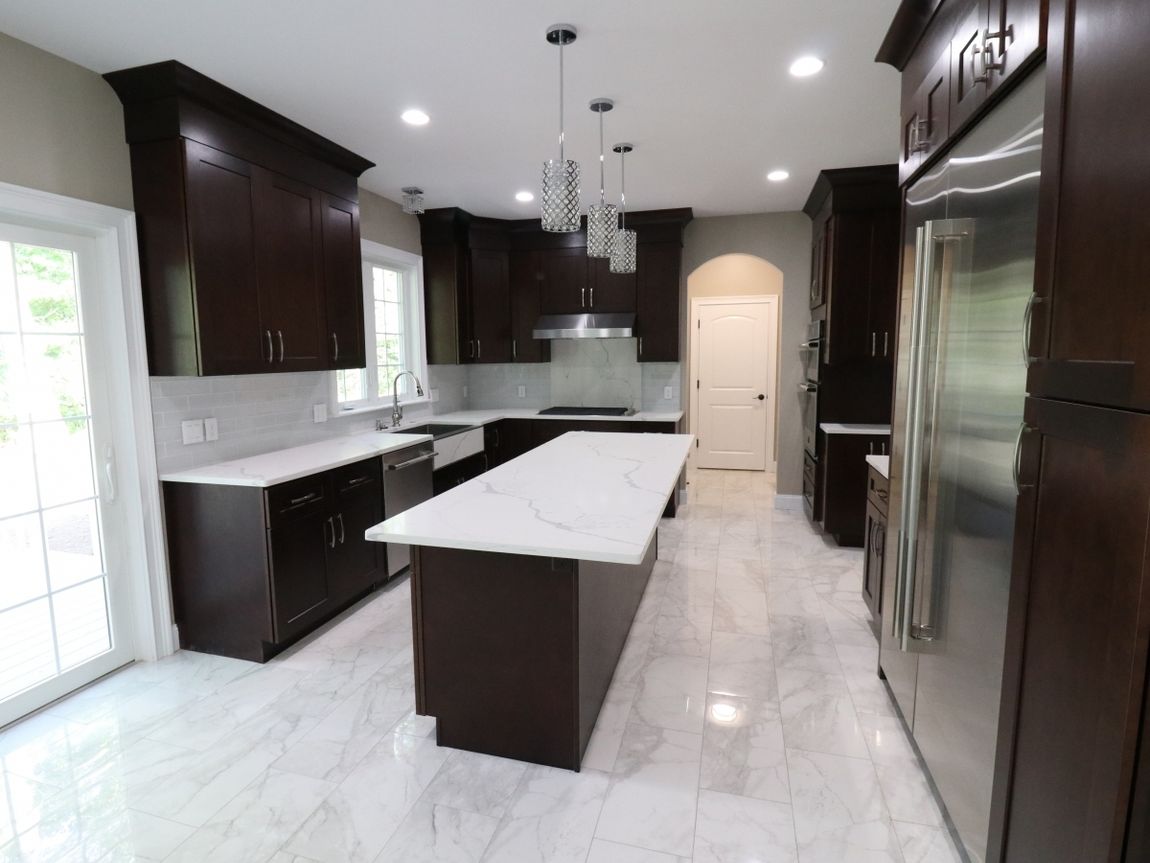 A kitchen with a large island and stainless steel appliances