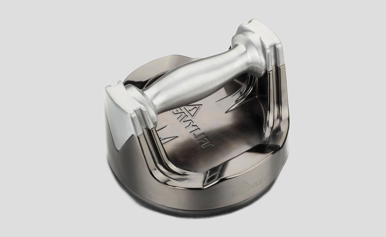 A close up of a metal object on a white background