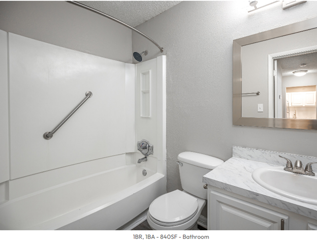 A bathroom with a toilet a sink and a bathtub