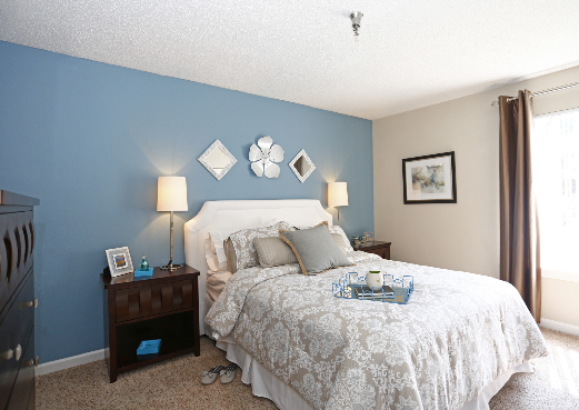 A bedroom with a large bed and blue walls