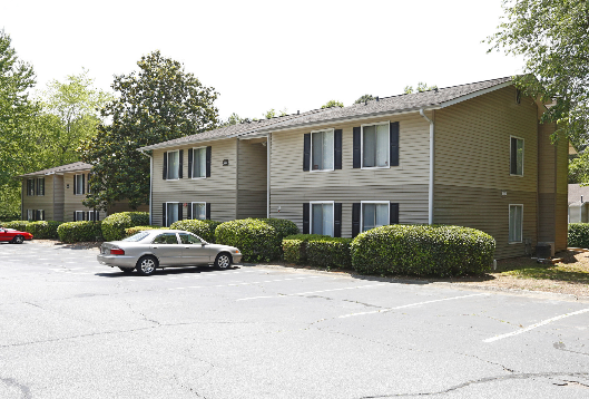 A building with a car parked in front of it