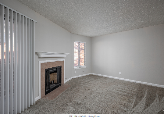 An empty living room with a fireplace and blinds
