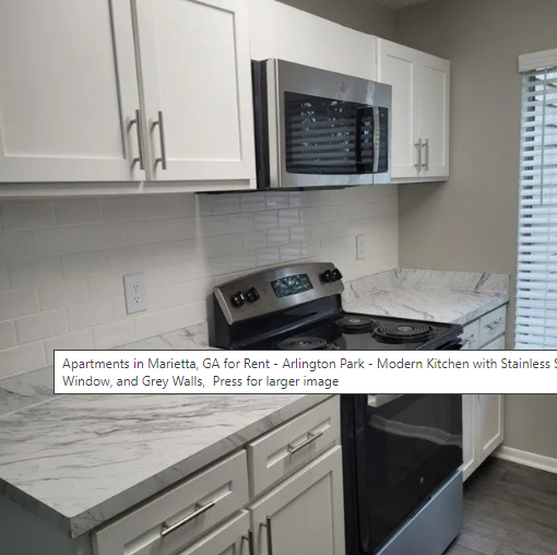 A kitchen with stainless steel appliances and white cabinets