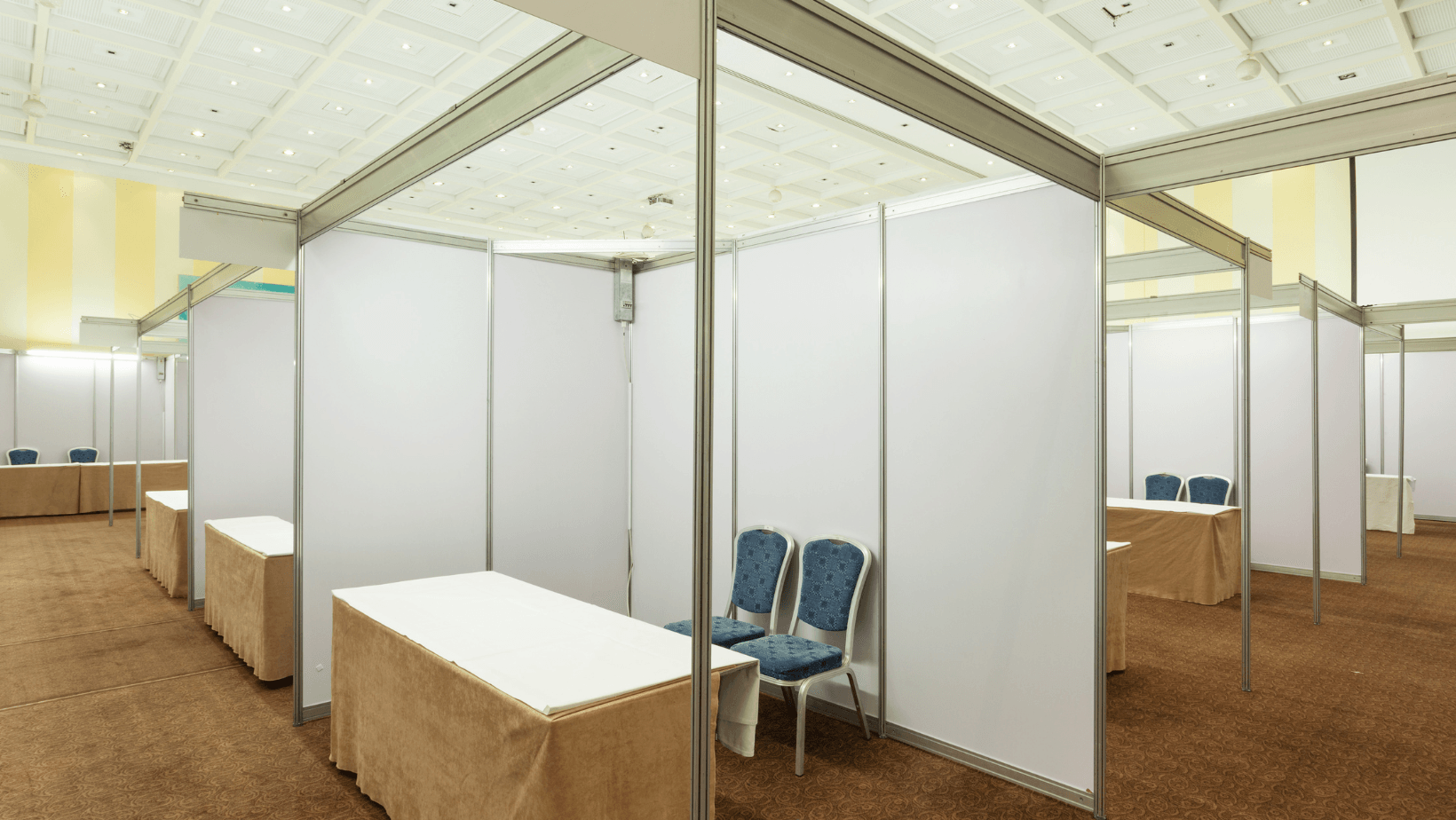 There are many tables and chairs in the room.