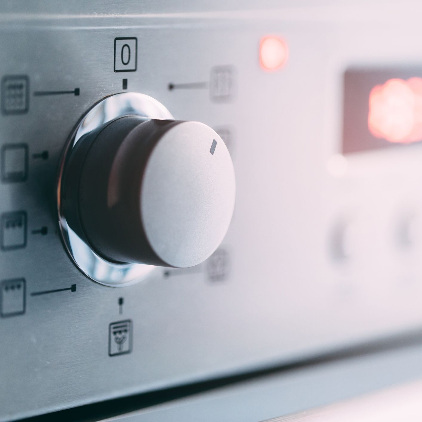 A close up of a stove knob with the number 0 on it