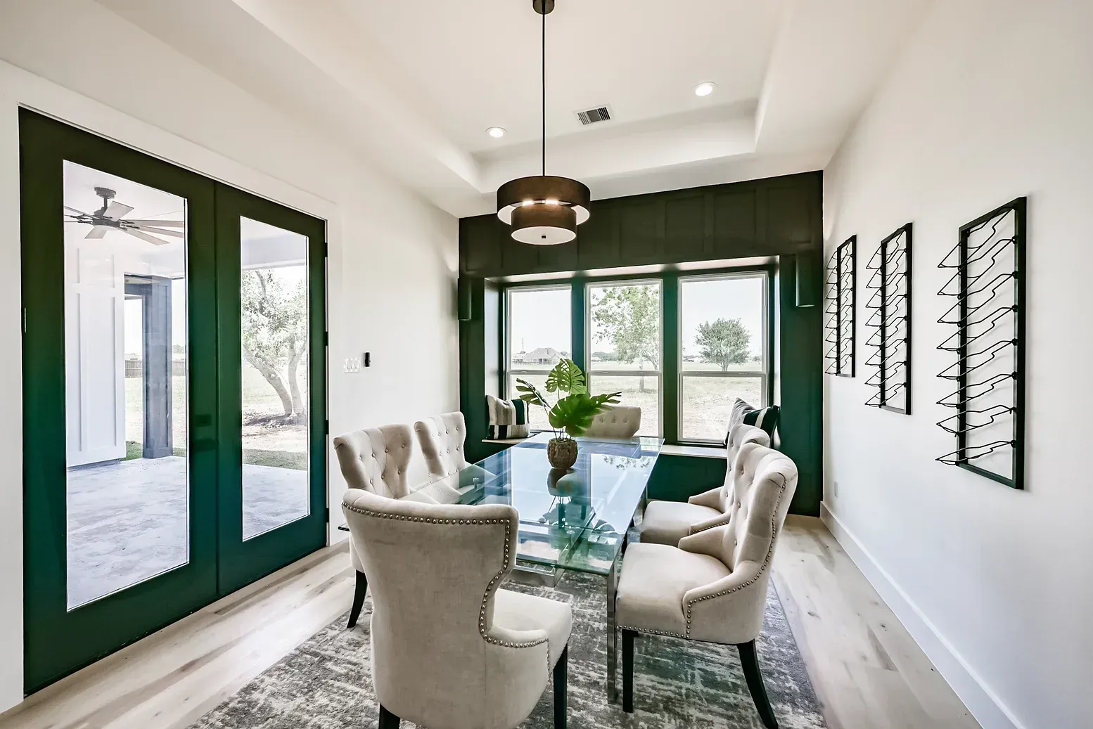 A dining room with a table and chairs and a ceiling fan.