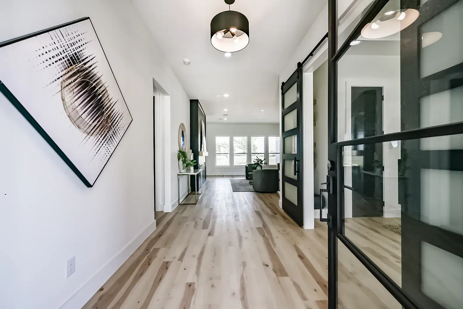 A hallway with hardwood floors and a painting on the wall