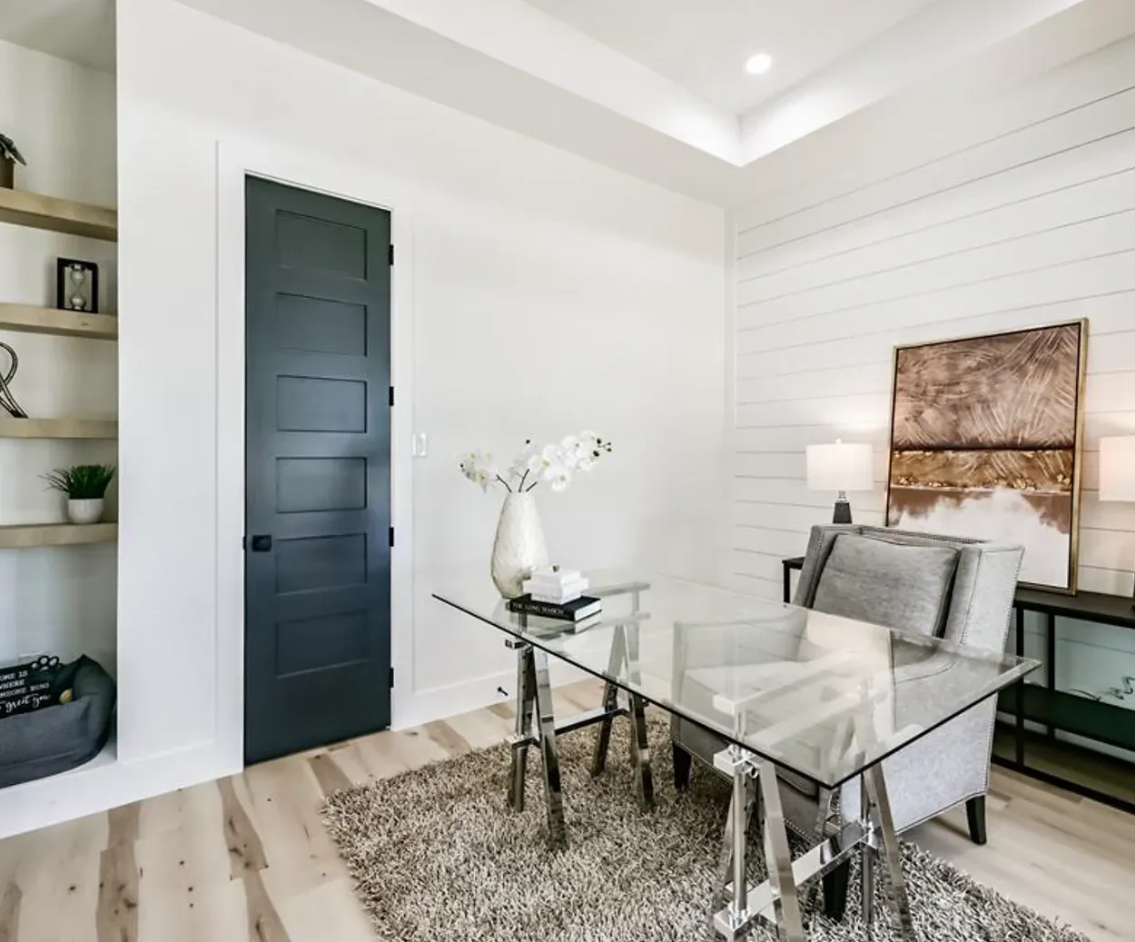 A home office with a glass desk and chairs