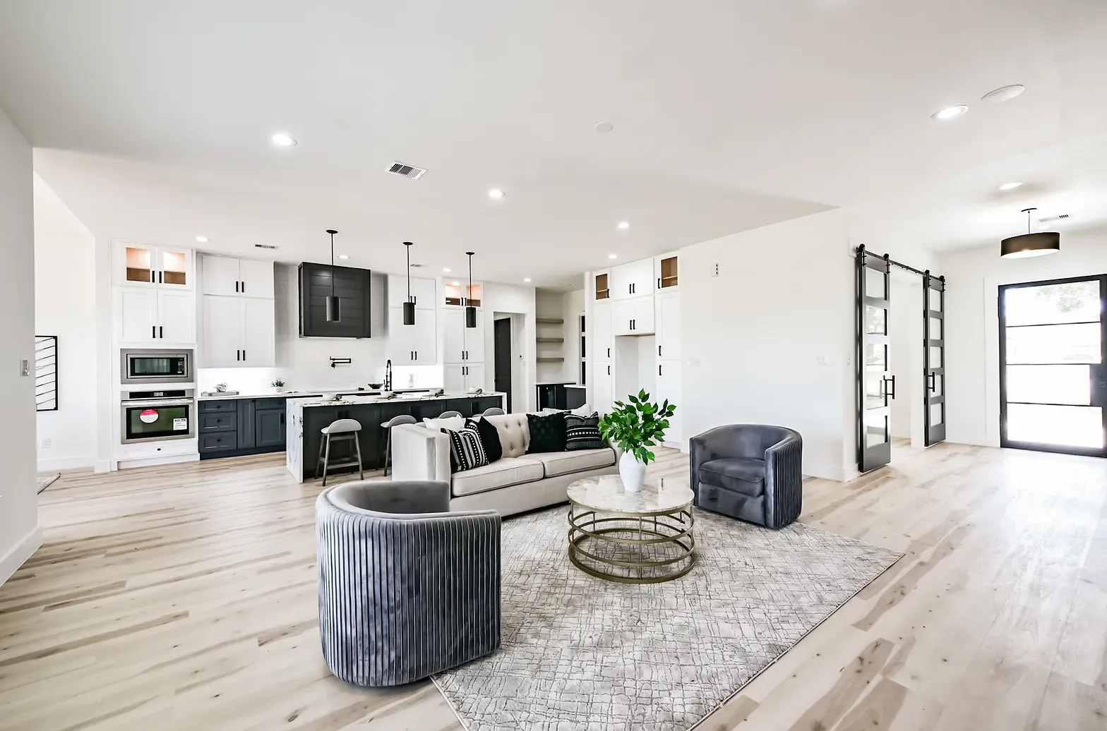 A living room with a couch , chairs , and a coffee table.