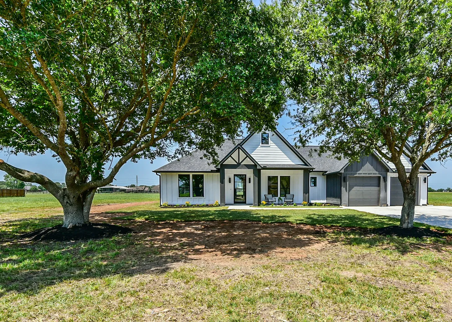A house with a lot of trees in front of it.