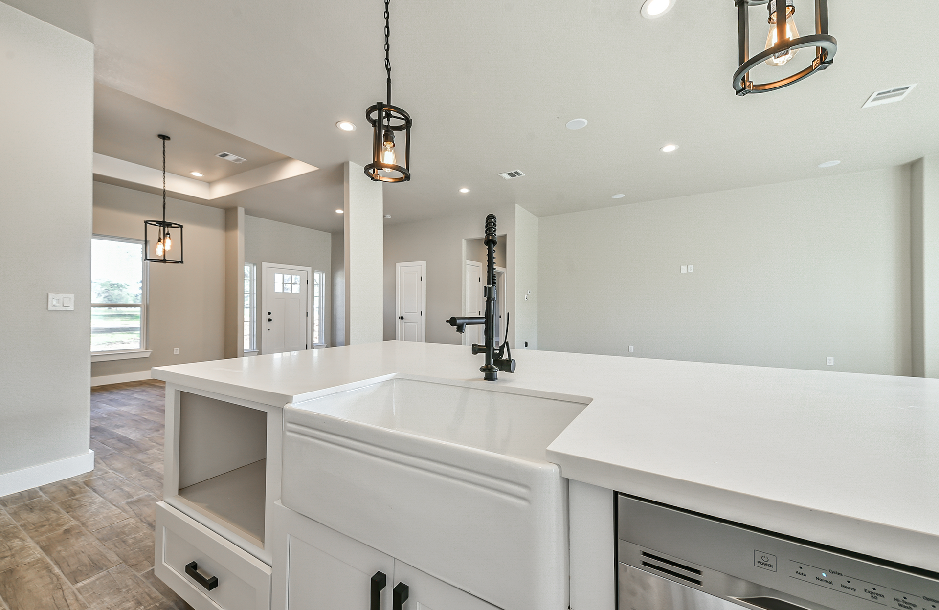 A kitchen with a farmhouse sink and a dishwasher.