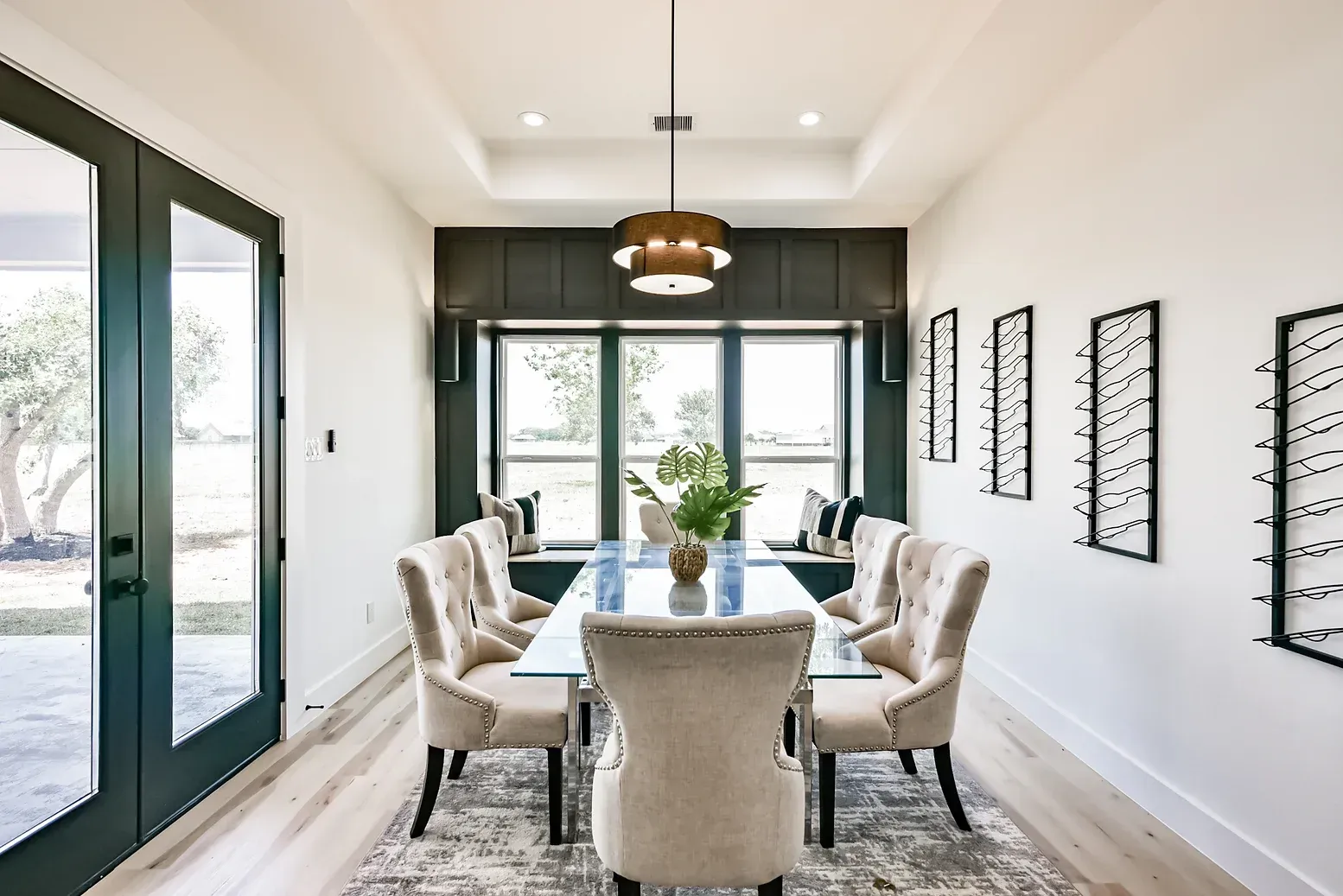 A dining room with a table and chairs and a window